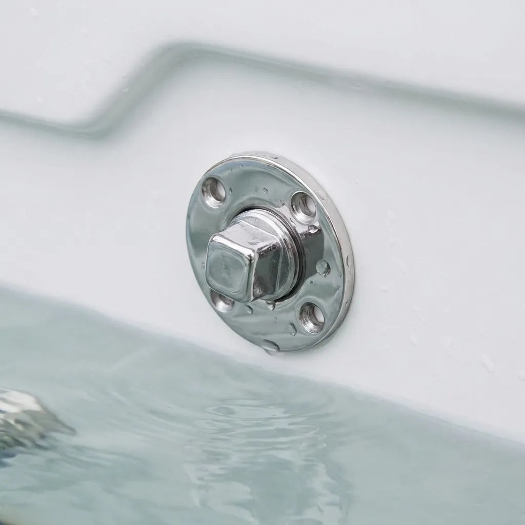 The stainless steel garboard drain plug shown installed in a white boat hull, partially submerged to demonstrate watertight integrity.