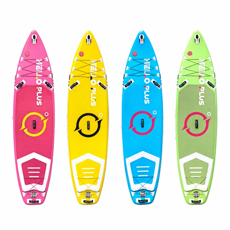 Four inflatable stand-up paddleboards in pink, yellow, blue, and green, with bungee cargo storage and central fin box, on a white background.