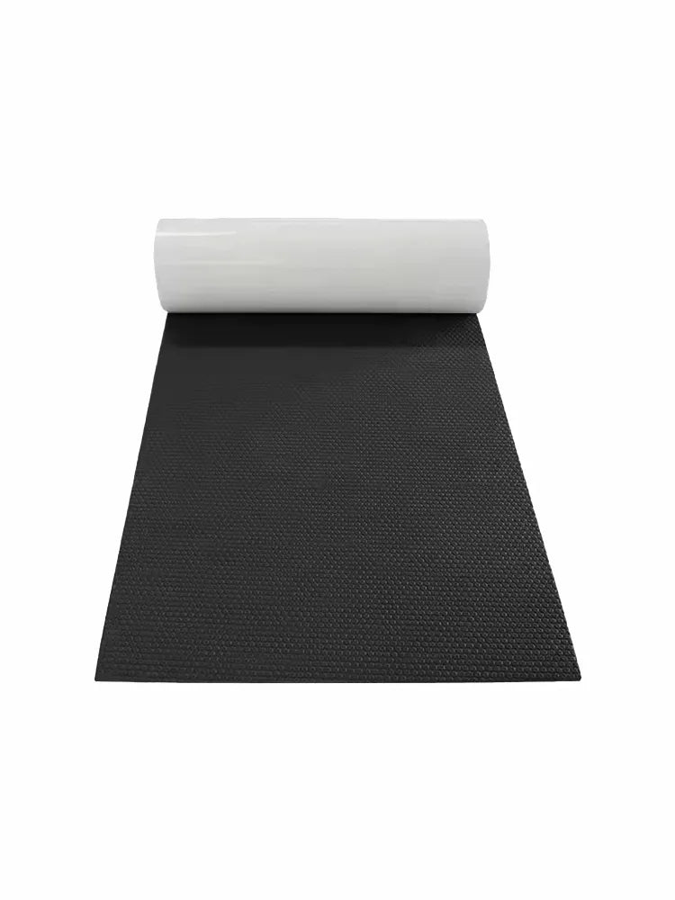 Rolled dark gray hexagonal textured EVA foam marine decking mat with white self-adhesive backing, unrolled on a white background