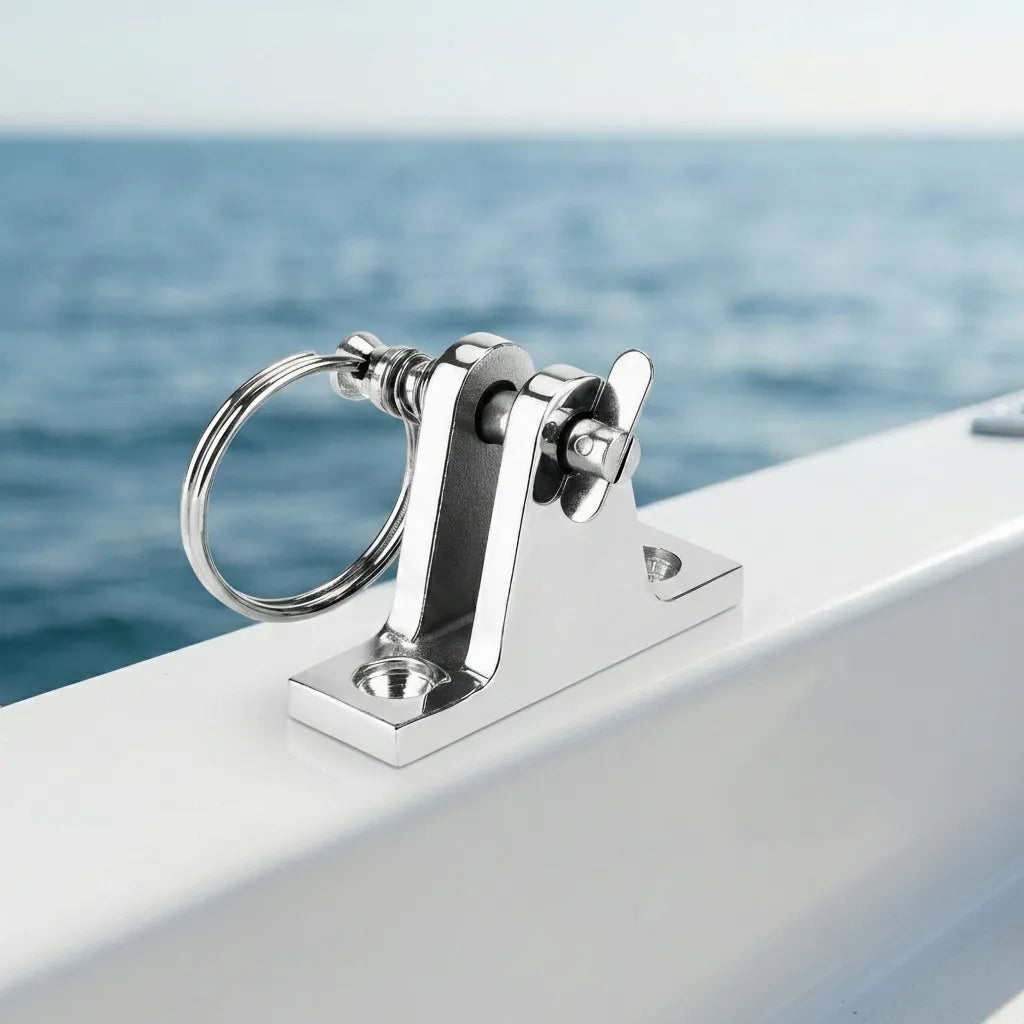 A mirror-polished stainless steel deck hinge installed on a white boat gunwale with the ocean in the background, demonstrating marine environment compatibility.