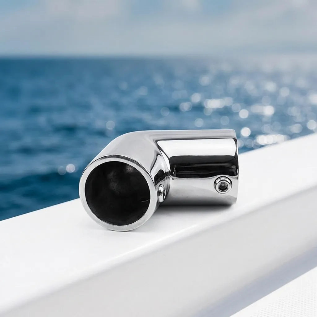 The mirror-polished stainless steel stanchion elbow installed on a yacht gunwale with the ocean in the background.