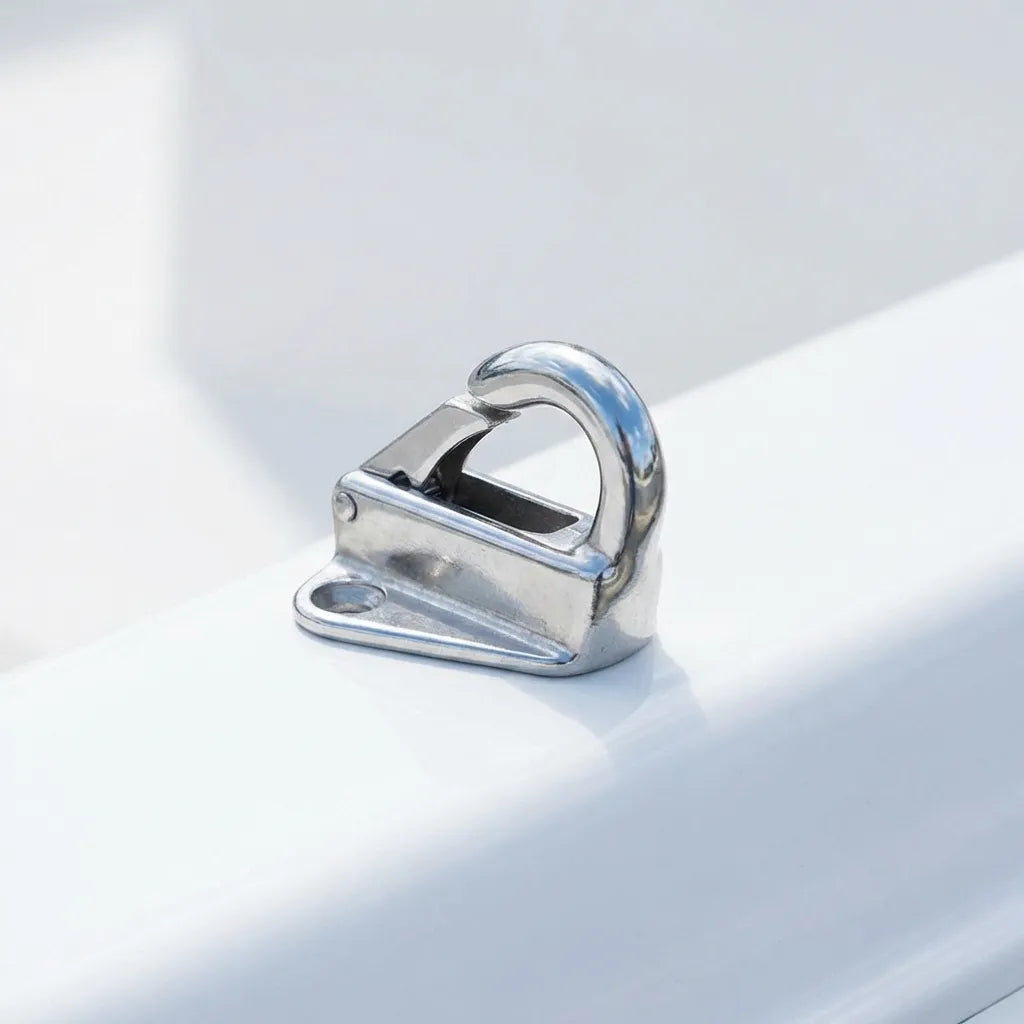 A mirror-polished stainless steel fender hook mounted on the white gelcoat gunwale of a modern vessel, demonstrating sleek integration.